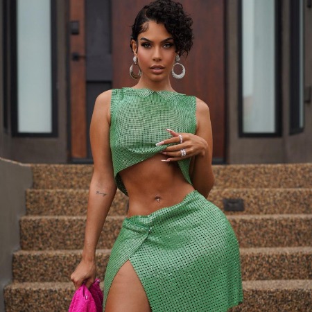 Amirah Dyme in green outfit flaunting her curvy body.